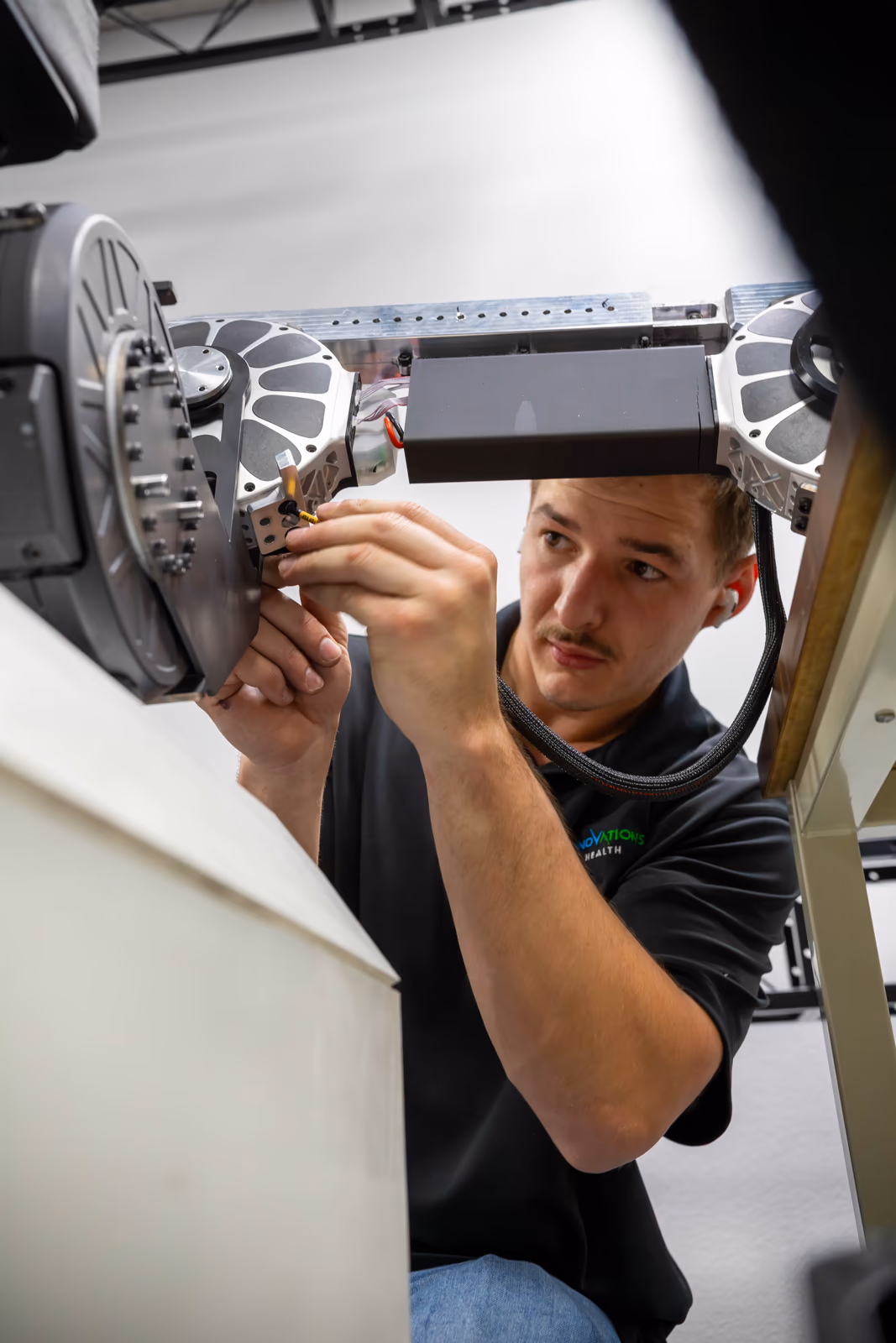 An Innovations Health engineer servicing the Kinoped actuator assembly