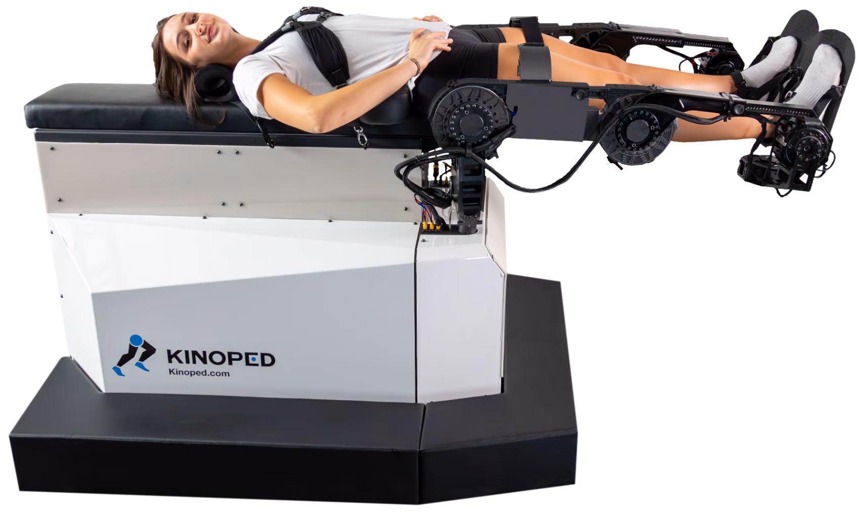 A subject positioned on the Kinoped platform with both legs engaged by the robotic force arms