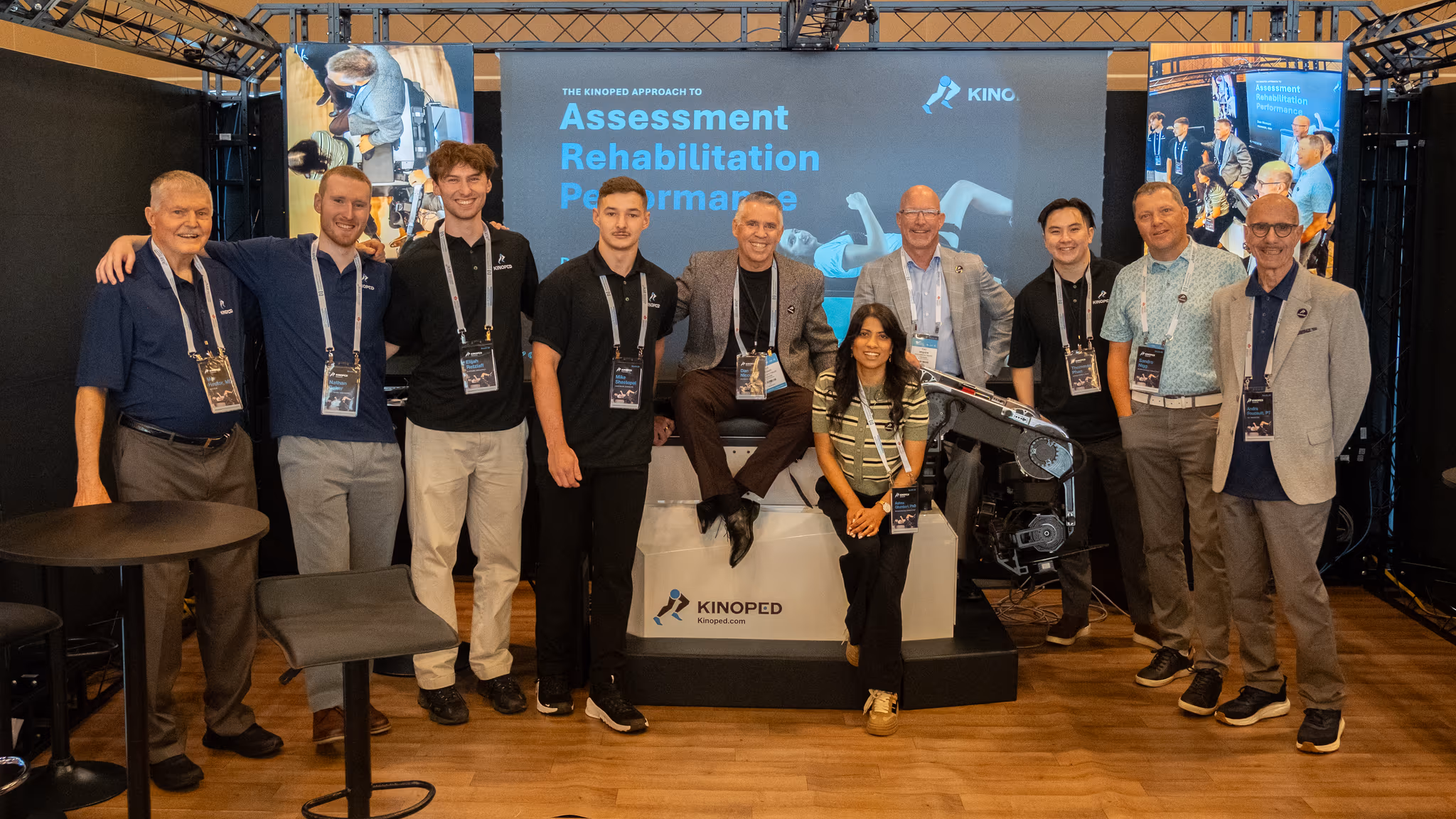 The Kinoped team gathered around the robot at the Kinoped exhibition booth
